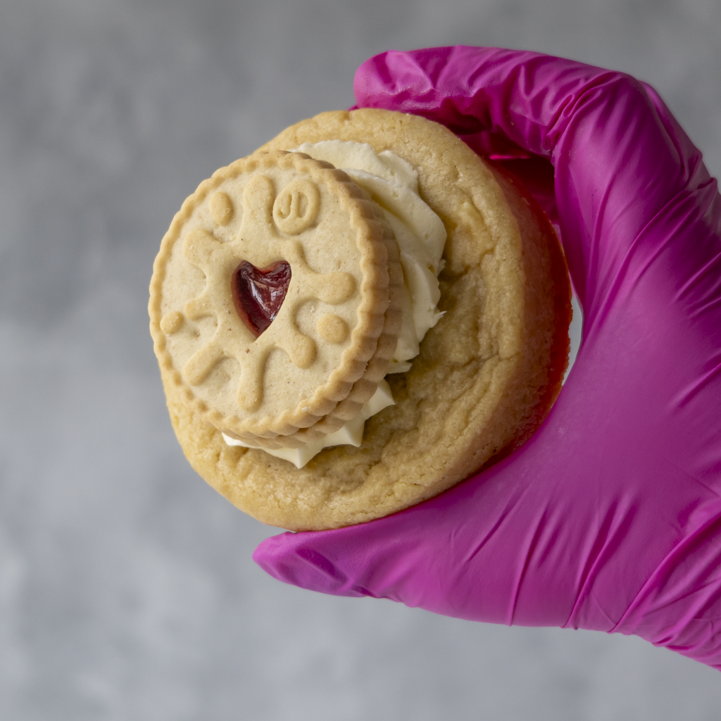 Angled view of DoughGirl Jammie Dodger cookie showing golden stuffed cookie base