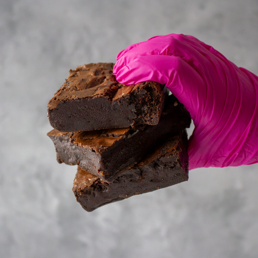 DoughGirl stacked chocolate brownies held by hand for a cookie party dessert