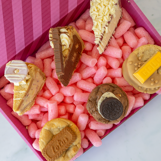 DoughGirl cookies and cookie pie slices arranged in a pink gift box