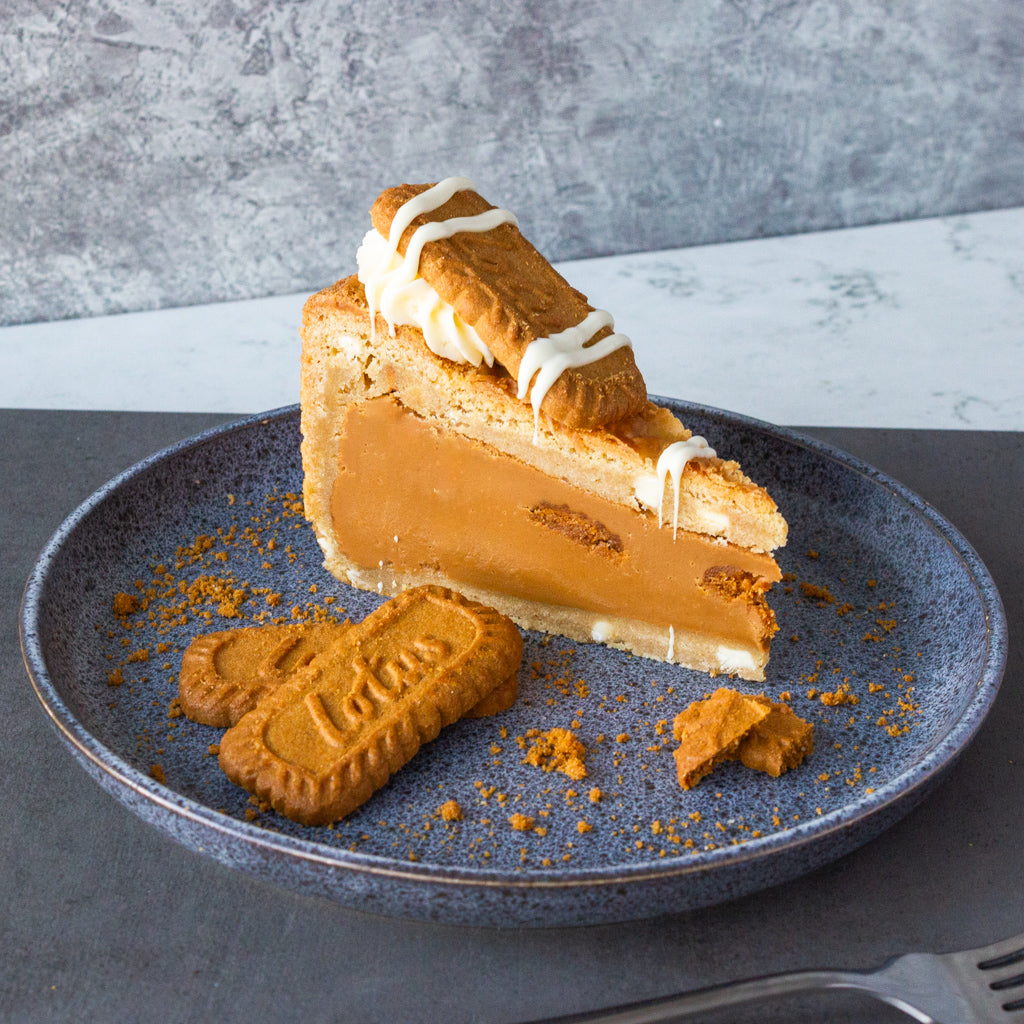 DoughGirl cookie pie slice with Biscoff biscuit, caramel filling and whipped topping on a plate