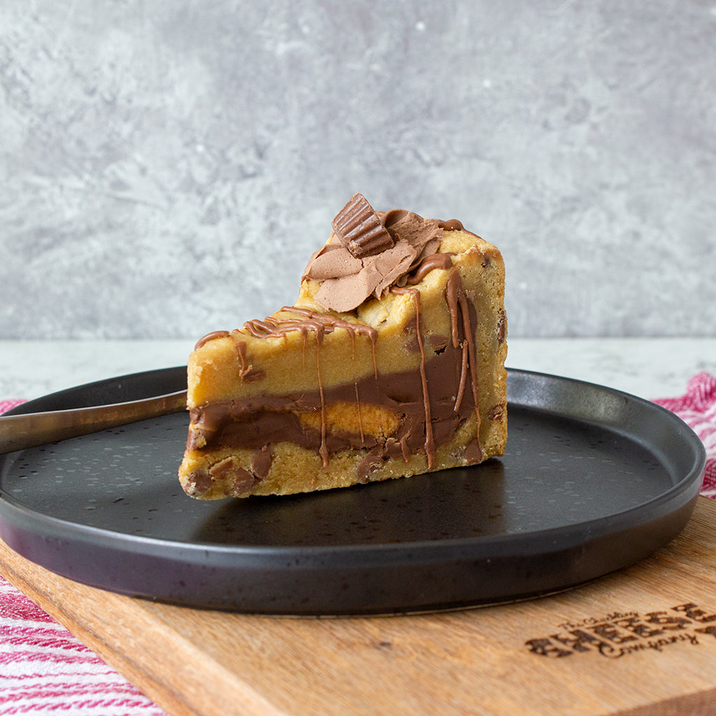 DoughGirl cookie pie slice with chocolate topping and caramel layers on a plate
