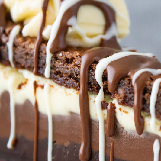 DoughGirl cookie pie close up with chocolate drizzle, white chocolate filling and brownie layers