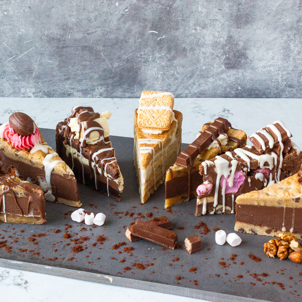 DoughGirl assorted cookie pie slices with chocolate drizzle and toppings on a dessert board