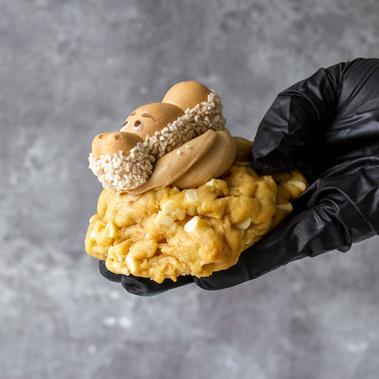 DoughGirl NYC-style chunky cookie with cookie dough topping held by hand