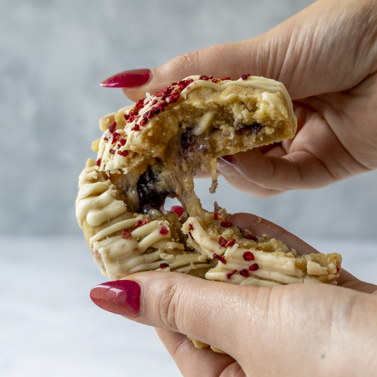 Broken stuffed cookie showing gooey filling and soft baked texture