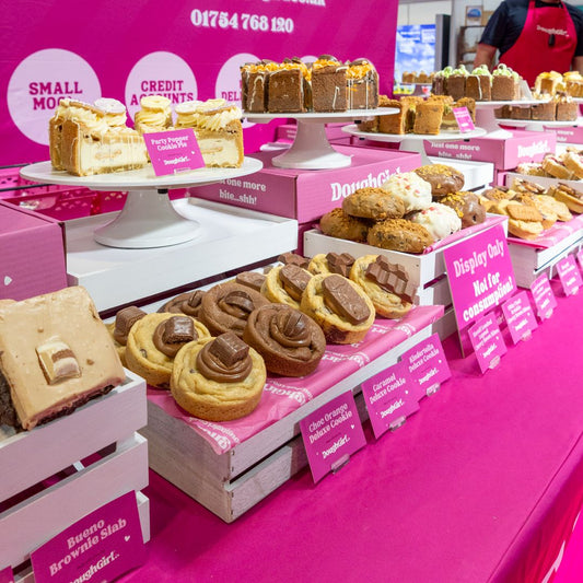 DoughGirl trade stand displaying Deluxe Cookies, Cookie Pies and Brownie Slabs