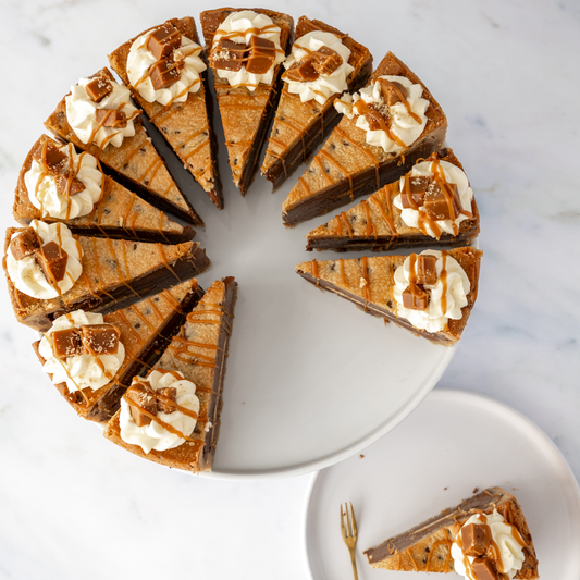 12 cookie pie slices arranged on a plate with caramel drizzle