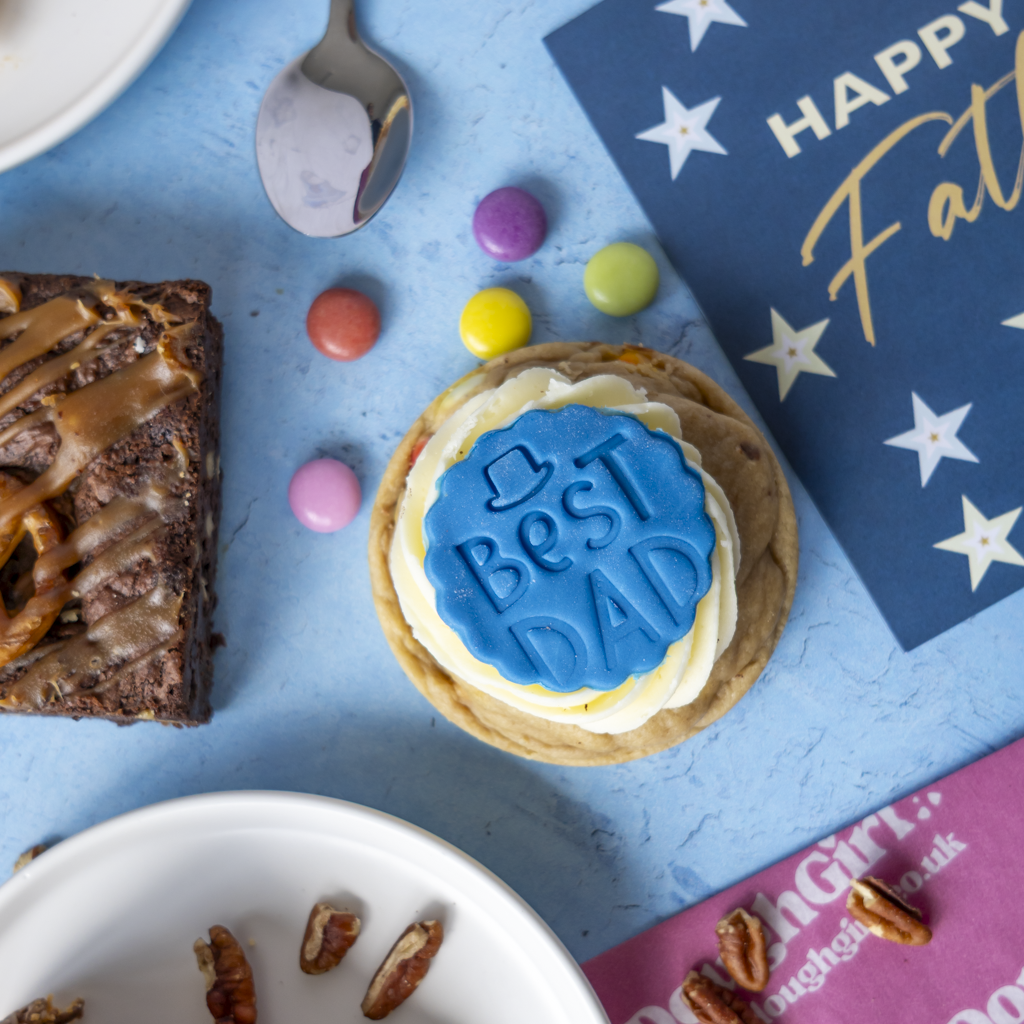 Father’s Day Cookie by DoughGirl UK topped with "Best Dad" icing fondant on blue background
