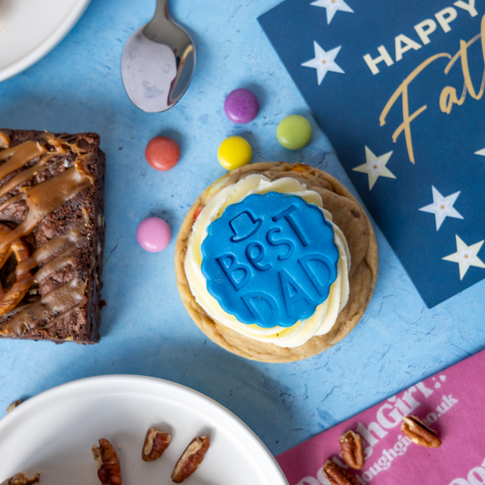 Father’s Day Cookie by DoughGirl UK topped with "Best Dad" icing fondant on blue background