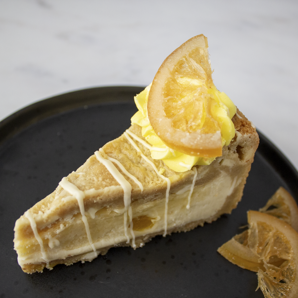 Lemon cookie pie slice with white chocolate drizzle and candied lemon
