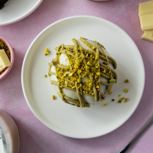 Top view of a Pistachio Boom Bite topped with pistachio drizzle and crushed pistachios