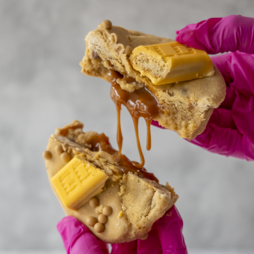 Stuffed cookie pulled apart with gooey caramel filling