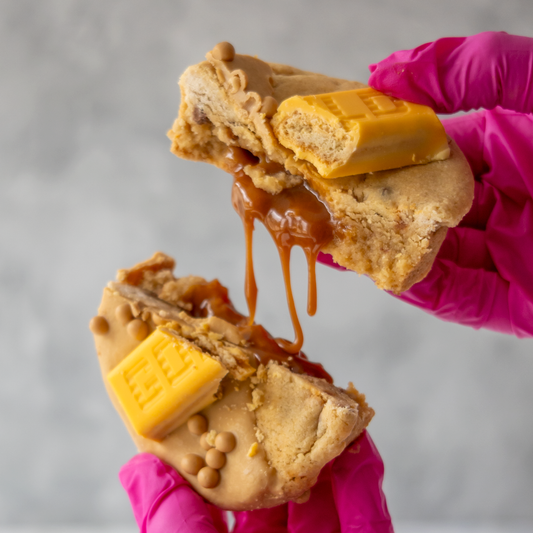 Stuffed cookie pulled apart with gooey caramel filling