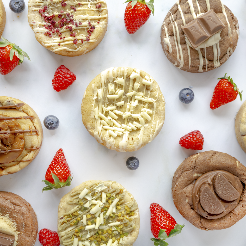 DoughGirl summer cookies with strawberries and blueberries on a white background, and a subtle summer feel. Store cookies in a cool dry place for the best texture.
