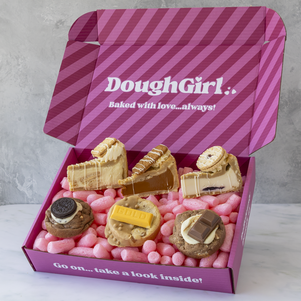 DoughGirl pink gift box filled with biscuit-inspired cookie pies, deluxe cookies and stuffed treats on pink packing sweets