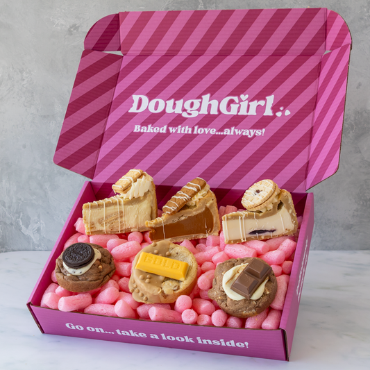 DoughGirl pink gift box filled with biscuit-inspired cookie pies, deluxe cookies and stuffed treats on pink packing sweets