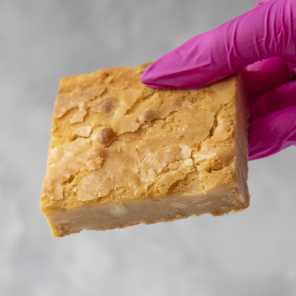 DoughGirl Classic Blondie Slab held in pink glove on grey background