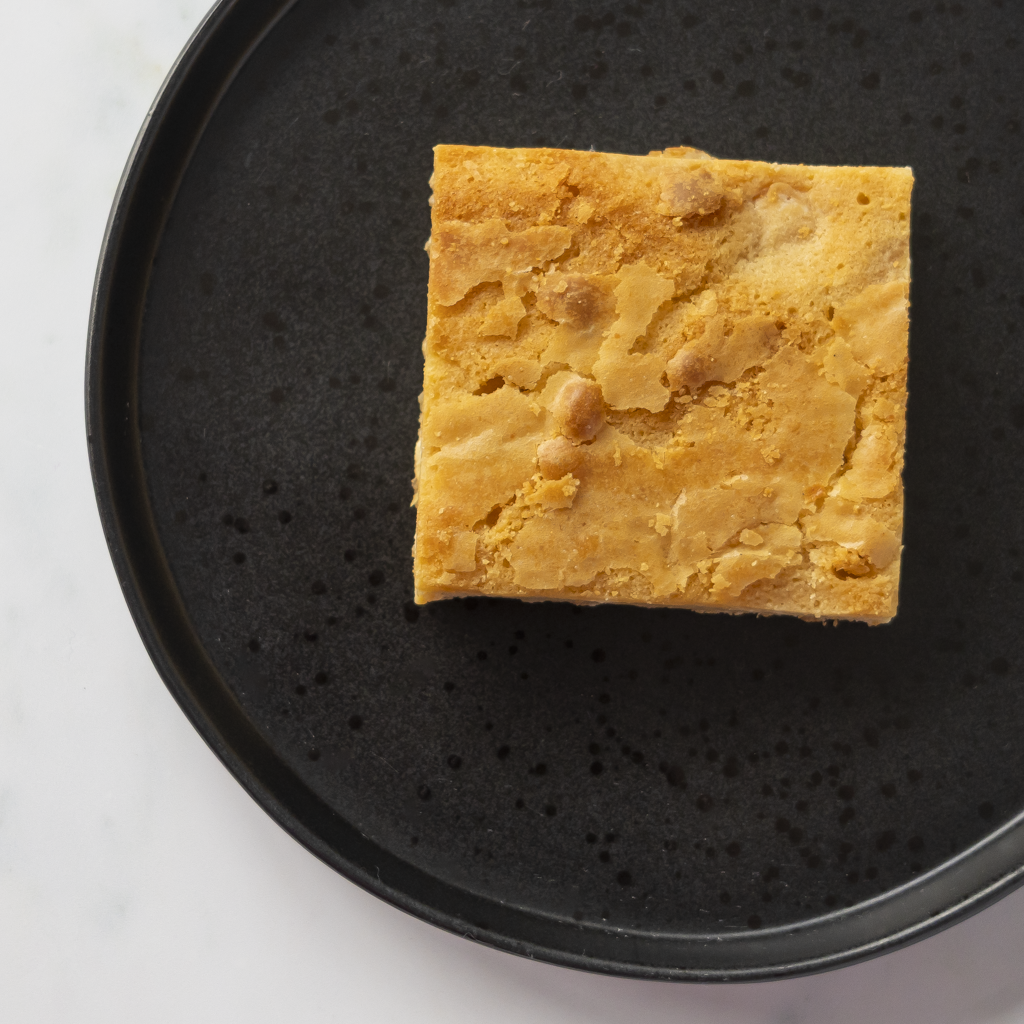 Overhead view of DoughGirl Classic Blondie Slab on black plate