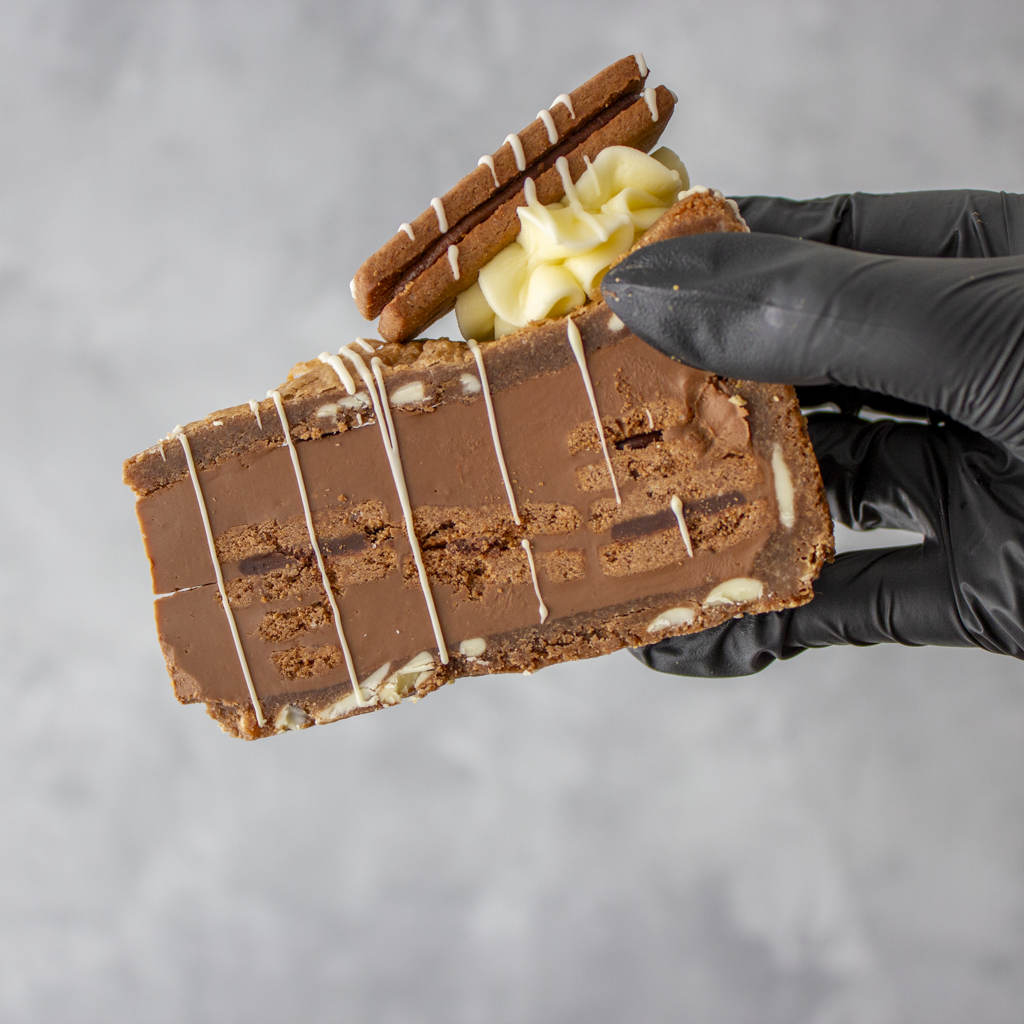 DoughGirl Bourbon Biscuit Cookie Pie Slice held in black glove showing thick chocolate filling