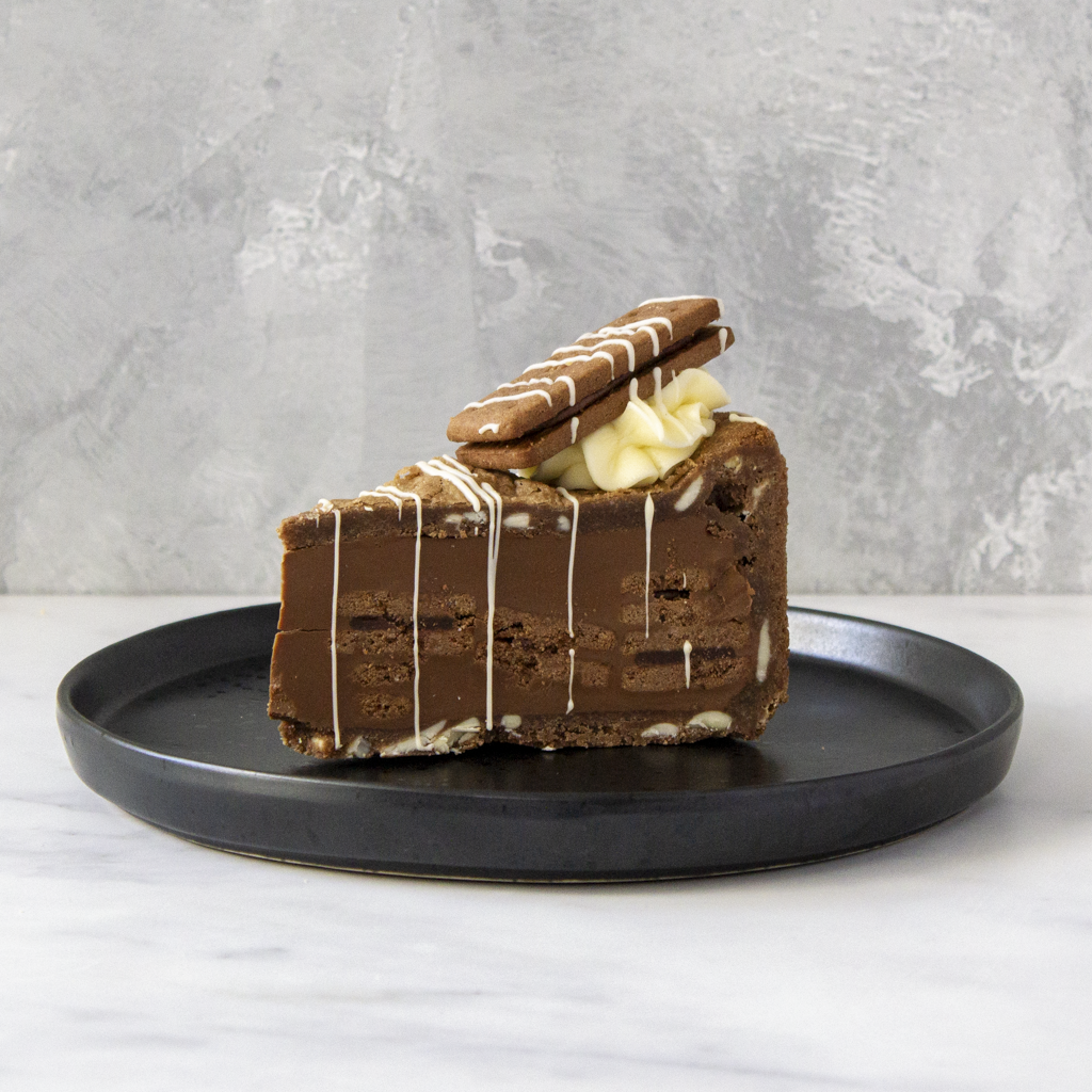 Bourbon Biscuit Cookie Pie Slice served on black plate with vanilla buttercream topping