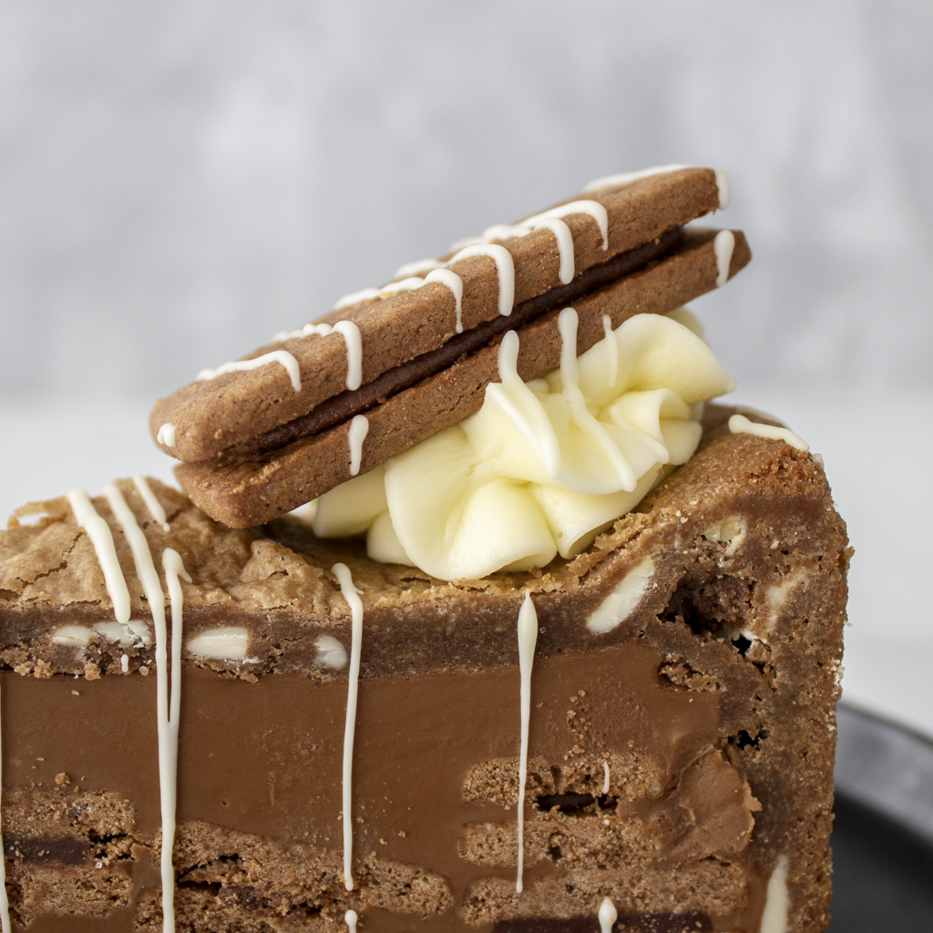 Side view of Bourbon Biscuit Cookie Pie Slice with chocolate base and buttercream