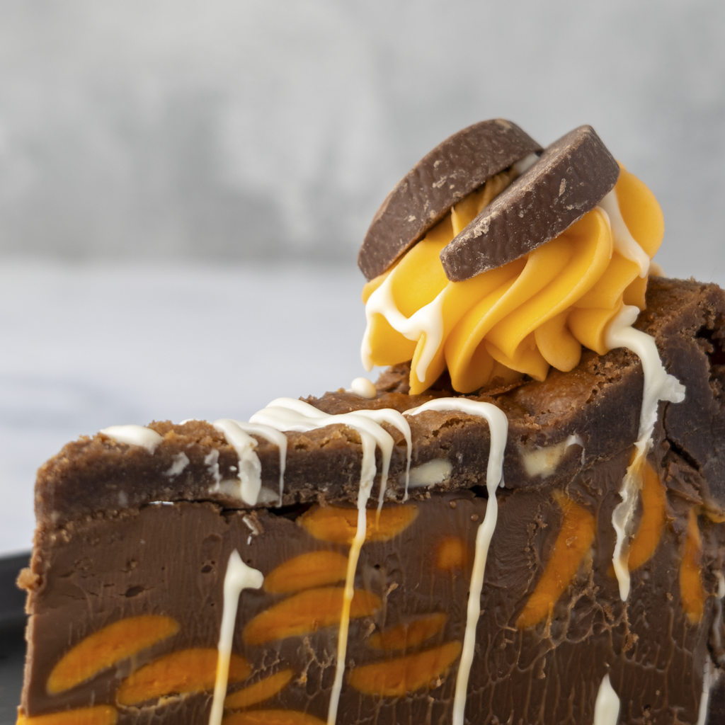 Close-up of Chocolate Orange Cookie Pie Slice with orange drizzle and chocolate topping