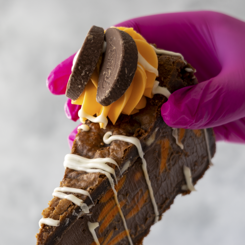 DoughGirl Chocolate Orange Cookie Pie Slice held in pink glove with chocolate filling