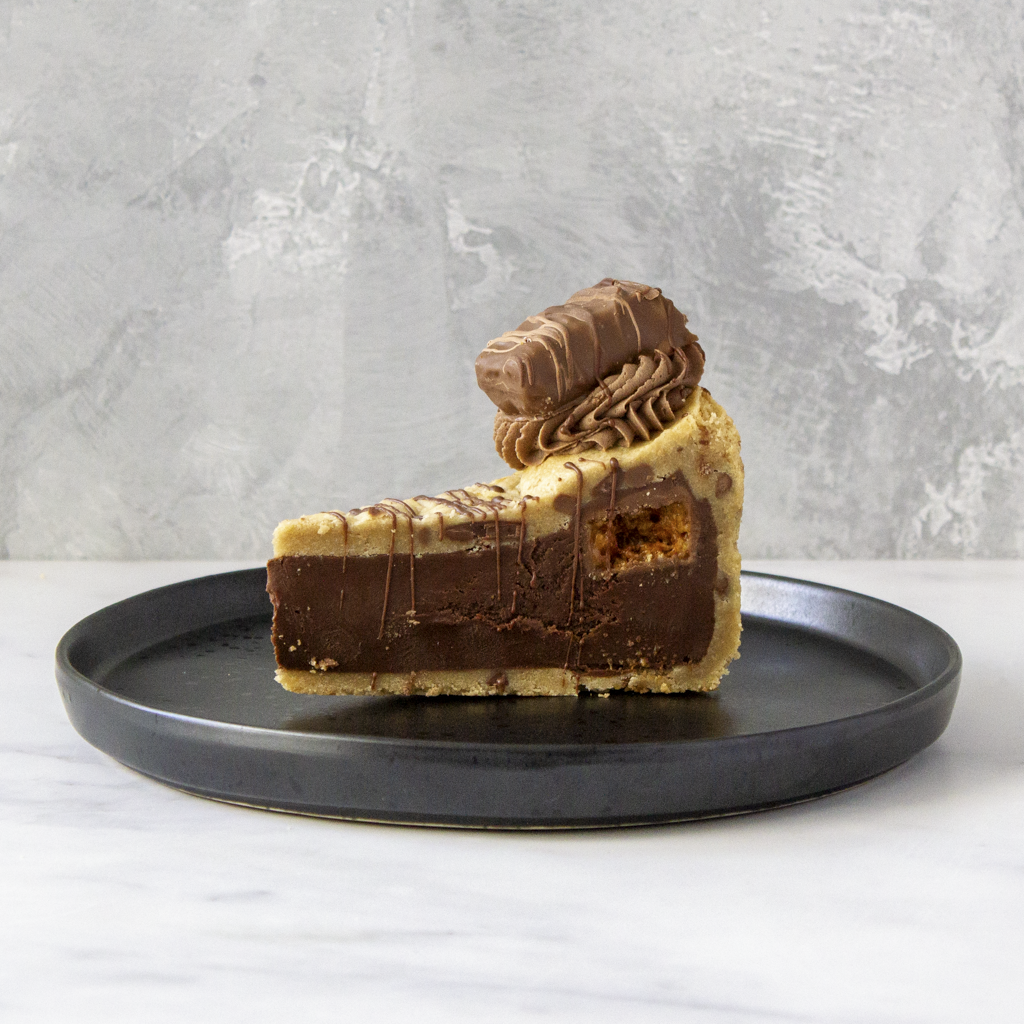 DoughGirl Crunchie Cookie Pie Slice served on black plate with chocolate topping