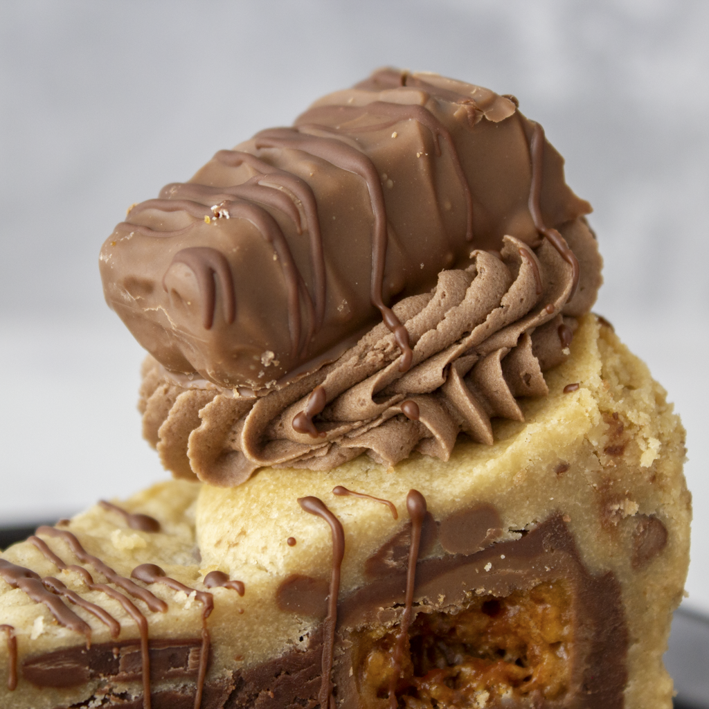 Close-up of Crunchie Cookie Pie Slice with chocolate buttercream and honeycomb pieces