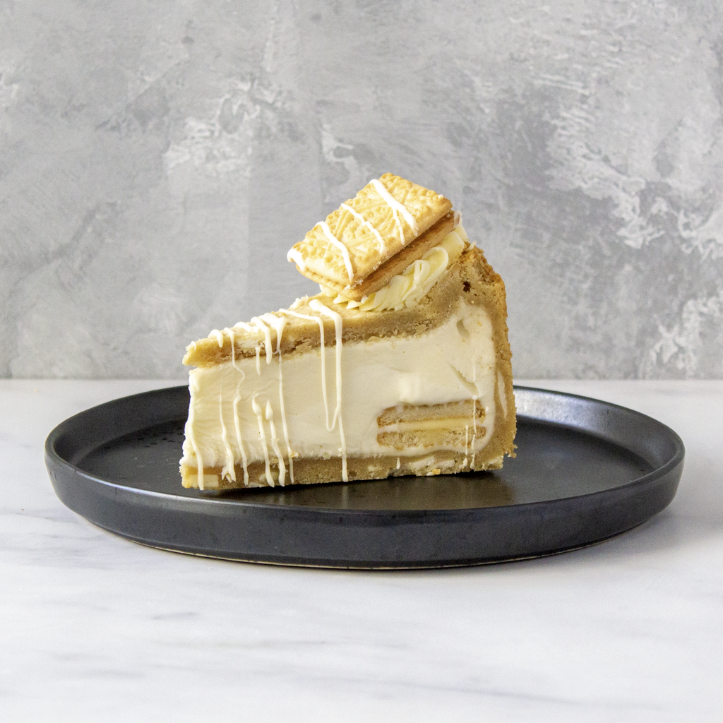 Custard Cream Cookie Pie Slice served on black plate with smooth white chocolate filling