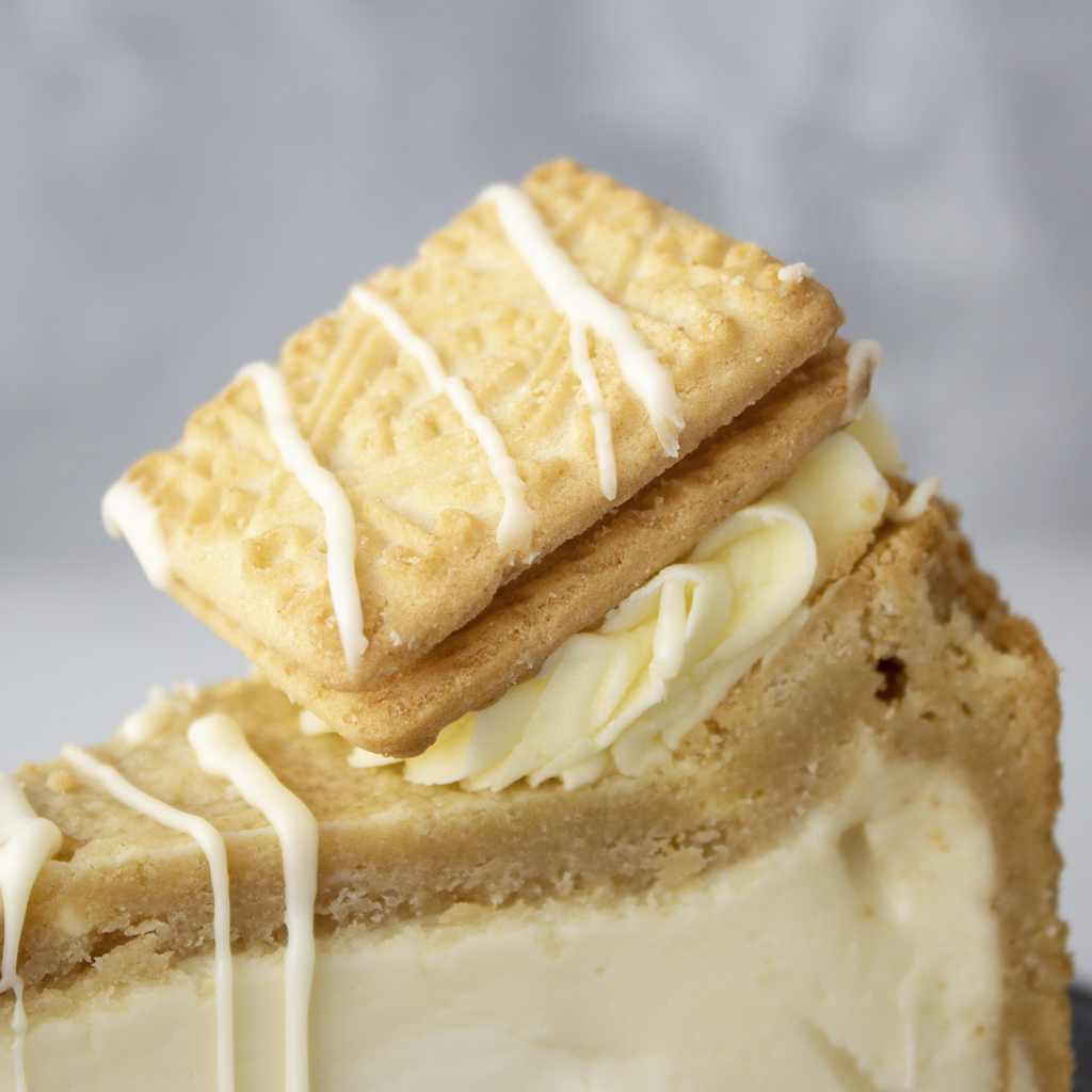 Close-up of DoughGirl Custard Cream Cookie Pie Slice with biscuit pieces and white chocolate drizzle