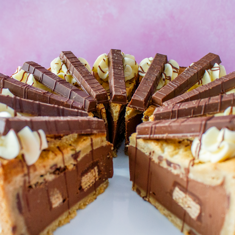 Full Cookie Pie with KitKat cut into slices with chocolate drizzle and crunchy wafer pieces