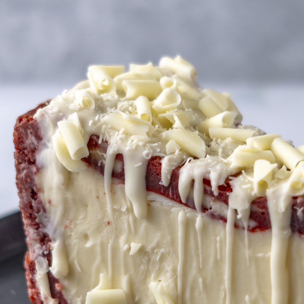 Close-up of Red Velvet Cookie Pie Slice with white chocolate drizzle and curls