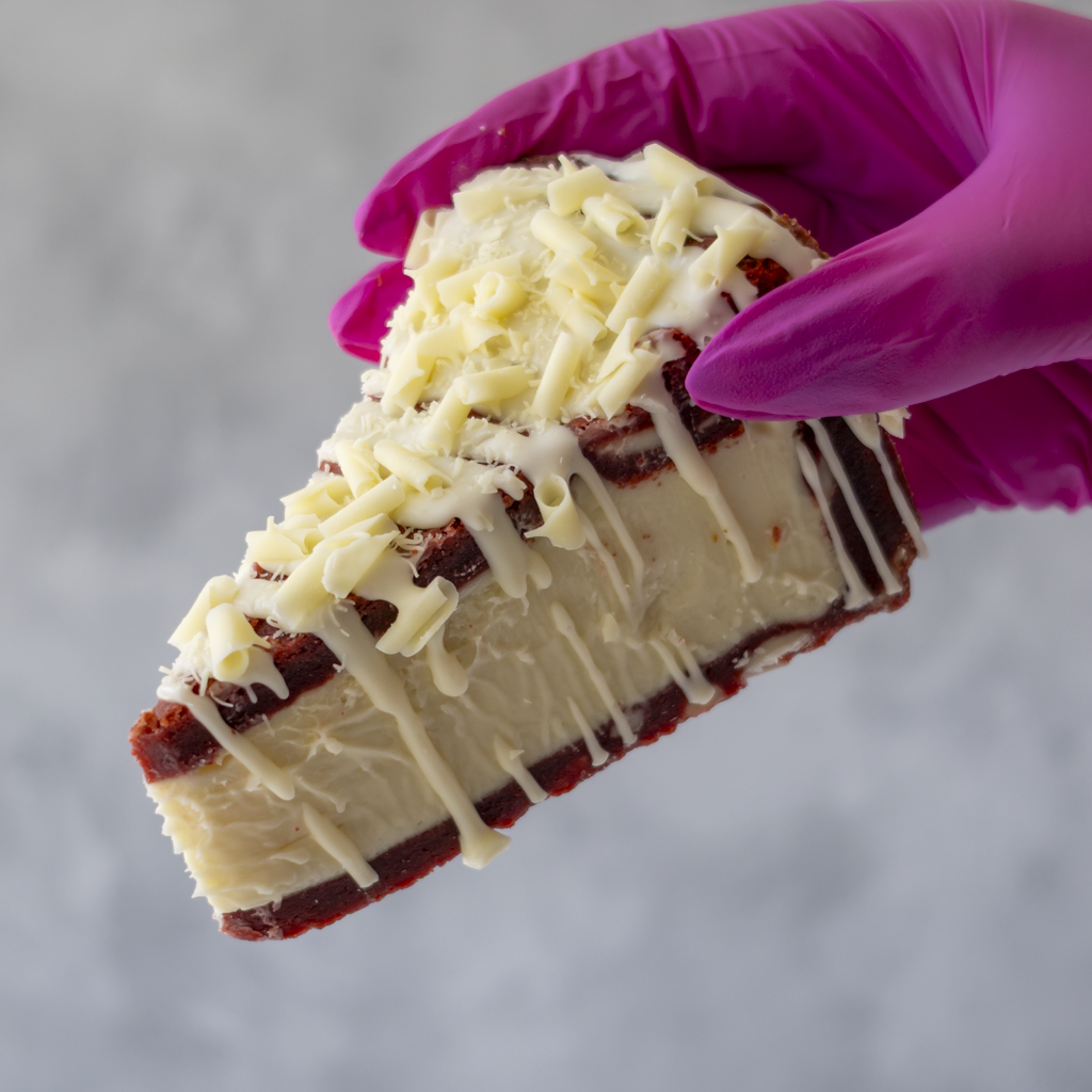 DoughGirl Red Velvet Cookie Pie Slice with white chocolate drizzle and curls