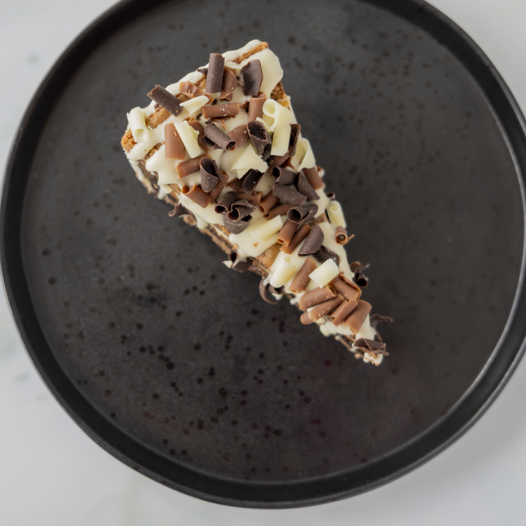 Overhead view of DoughGirl Triple Chocolate Cookie Pie Slice on black plate