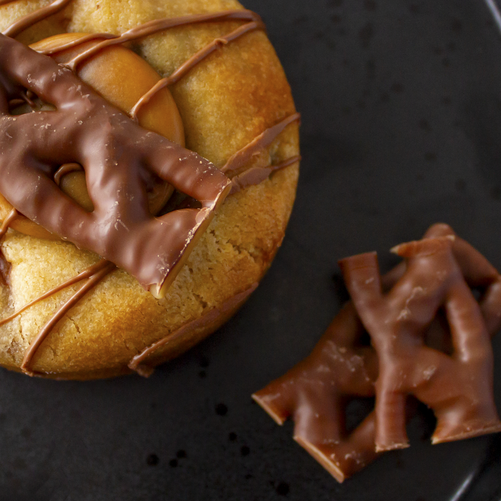 Close-up of Curly Wurly cookie with caramel drizzle and milk chocolate topping
