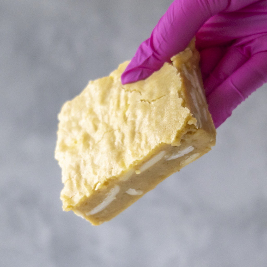 DoughGirl Classic Blondie Slab with a pink glove holding it against a gray background