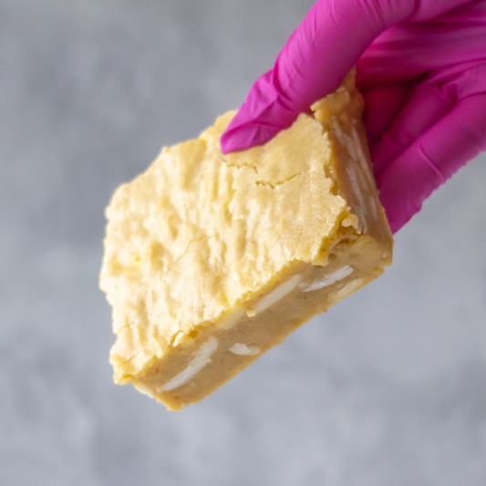 DoughGirl Classic Blondie Slab with a pink glove holding it against a gray background