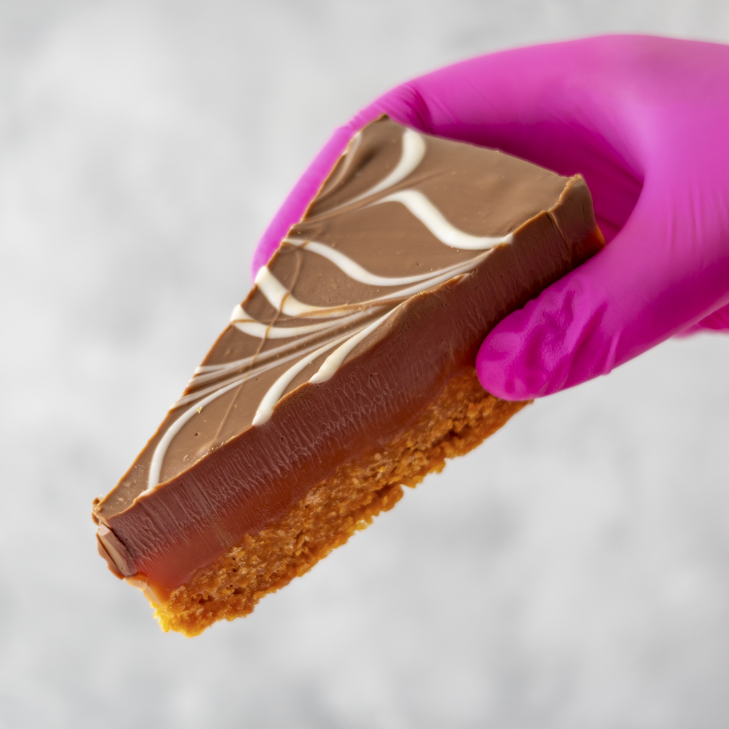 DoughGirl Millionaire Cornflake Pie Slice with caramel layer, chocolate topping and white chocolate drizzle