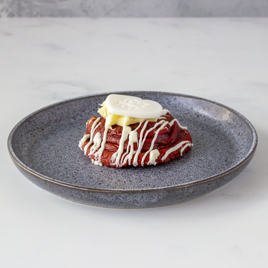 Red velvet cookie with cream on a gray plate