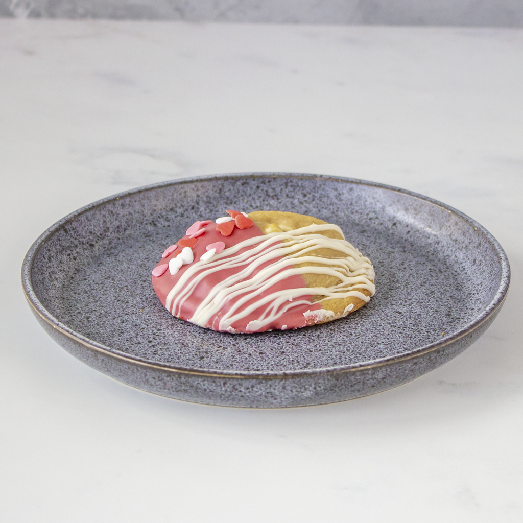 Colorful cookie dough on a gray plate with a light background