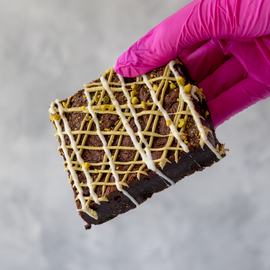 DoughGirl Pistachio Brownie Slab with white chocolate drizzle, pistachio drizzle and crushed pistachios