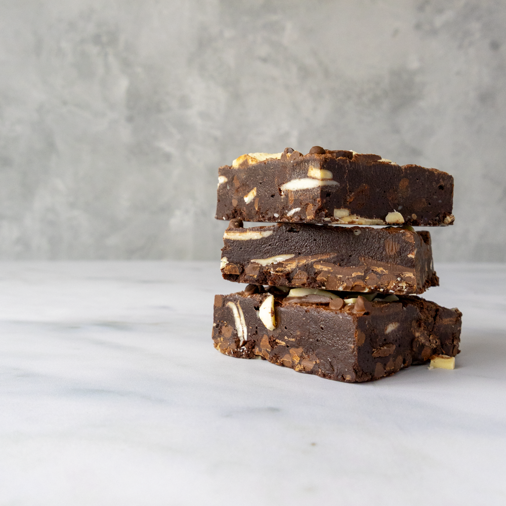 Stack of chocolate bars with chocolate chips on a marble surface