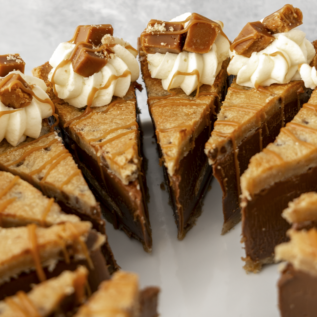 Close-up of a chocolate cookie pie with Banoffee fudge chunks on a white plate