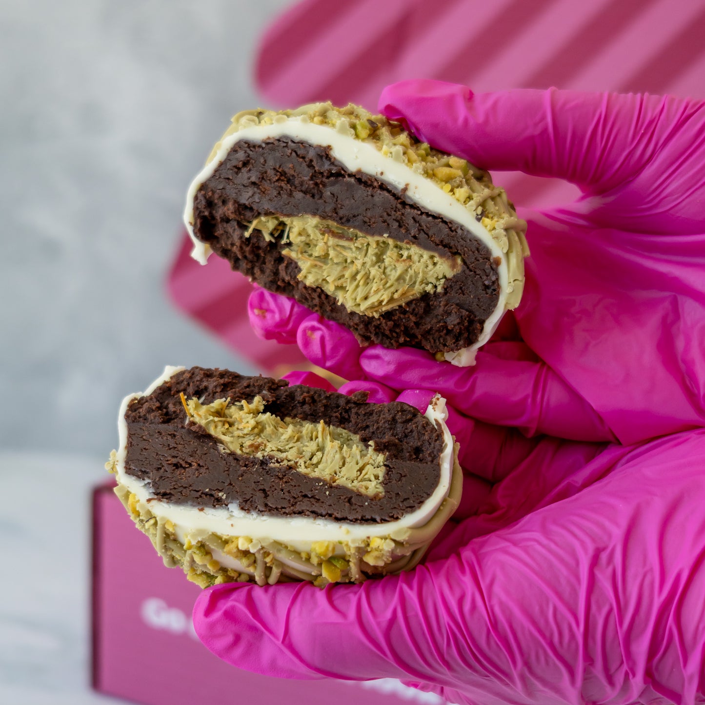 Holy Pistachioli Choccy Boom Bite cut open showing chocolate brownie shell and pistachio filling