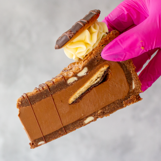DoughGirl Jaffa Cake Cookie Pie with a creamy filling held by a gloved hand on a neutral background
