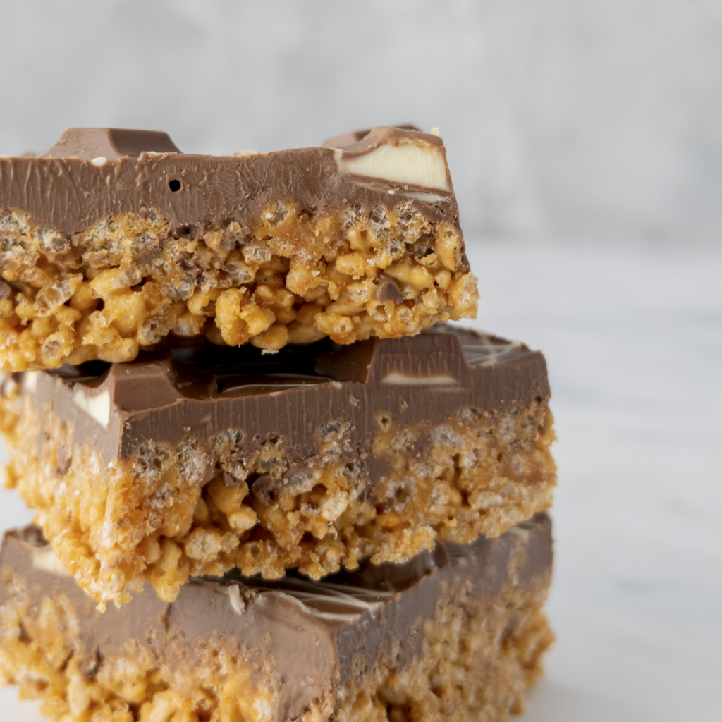 Close up zoom of layered Kinder Crispie Slab showing hazelnut chocolate, Kinder chunks and crispie base
