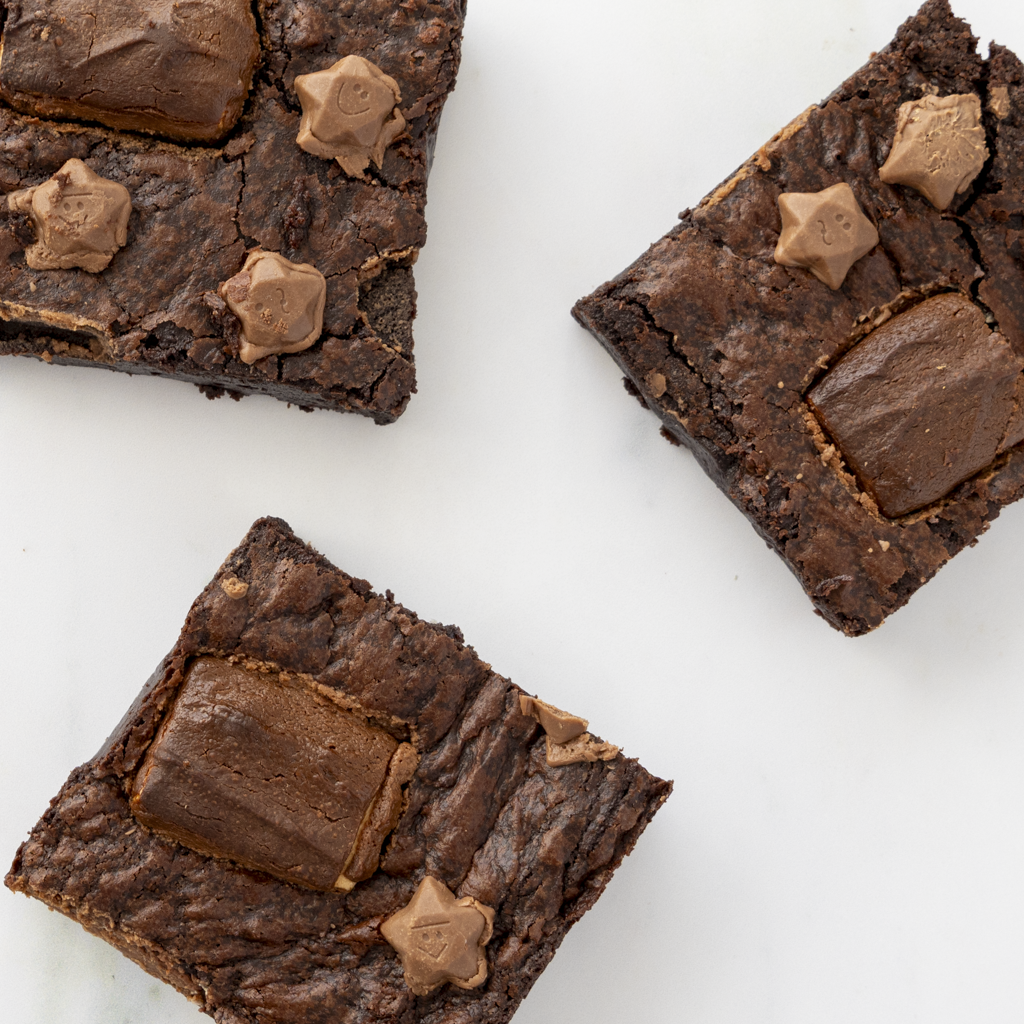 Three Milkyway Brownie Slab with chocolate chips on a white background