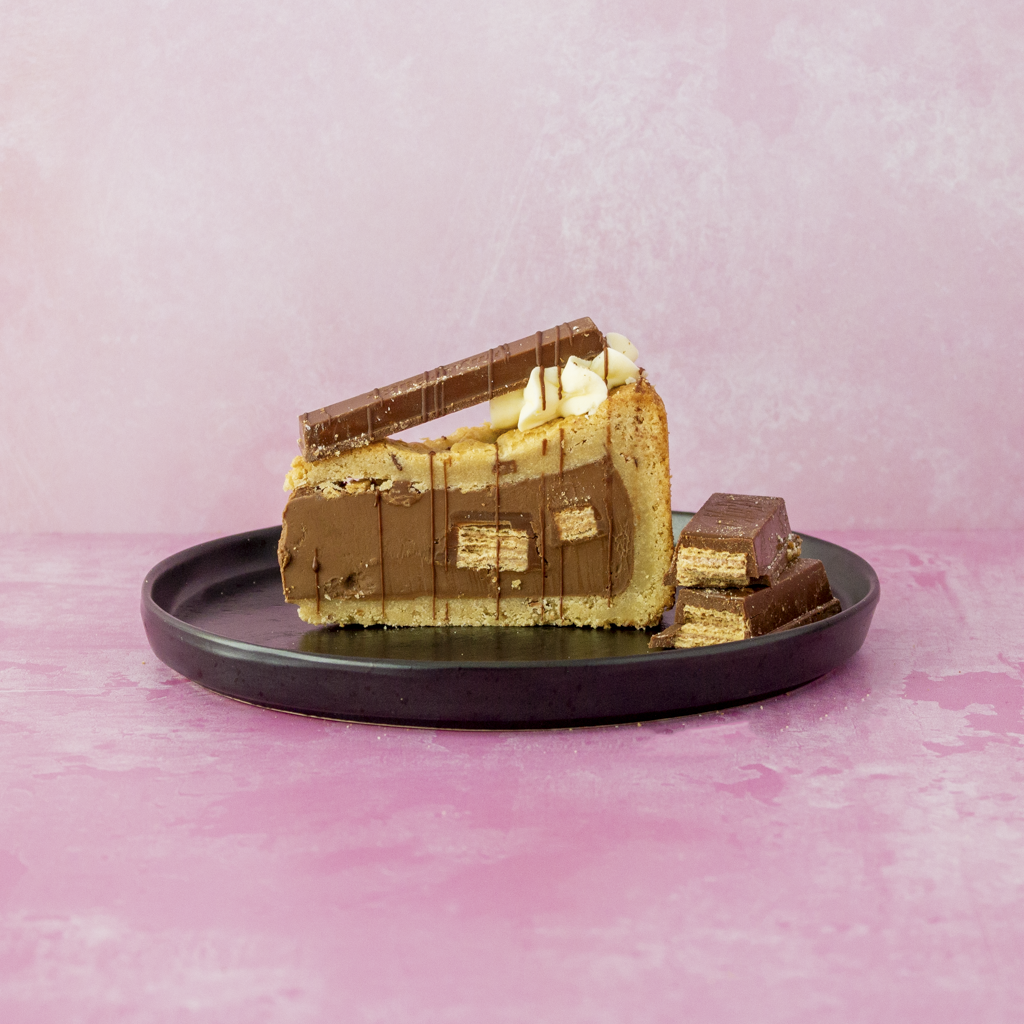 KitKat Crunch Cookie Pie on a black plate with a pink background