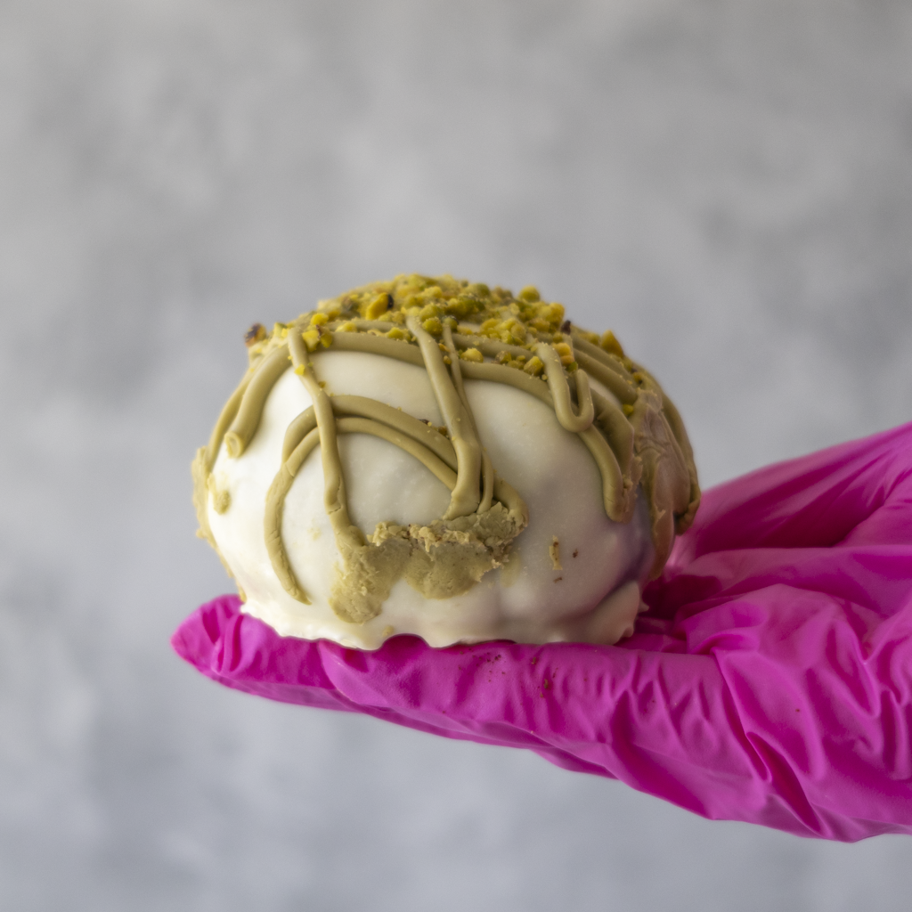 DoughGirl Holy Pistachioli Choccy Boom Bite with white chocolate, pistachio drizzle and crushed pistachios